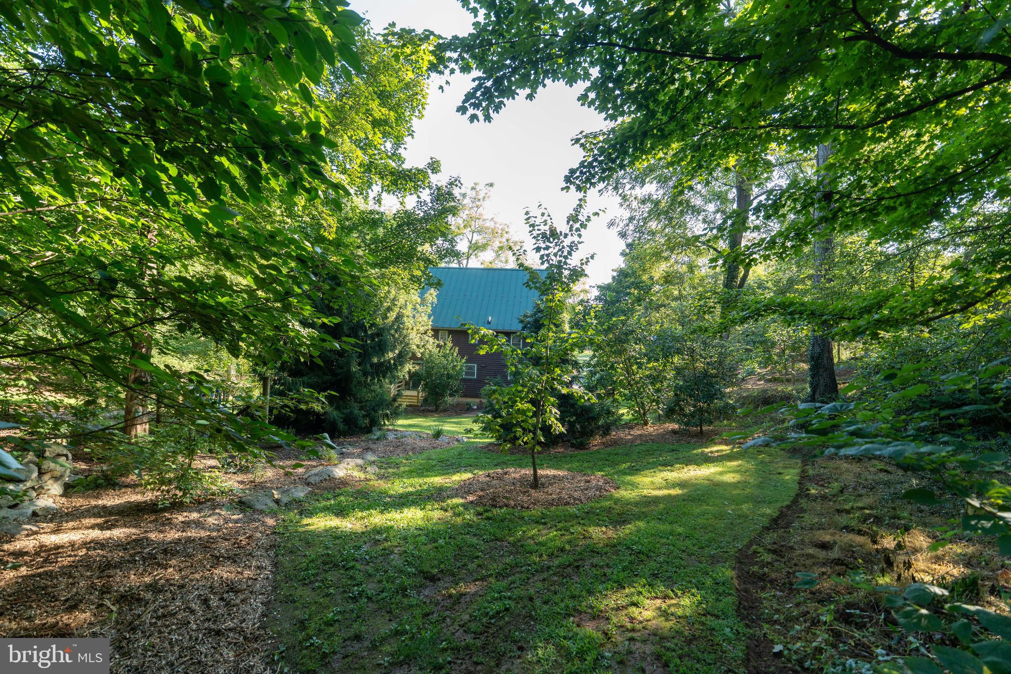 3171 Ritner Highway Newville, PA 17241 - Photo 8 of 63 a backyard of a house with lots of green space and fountain