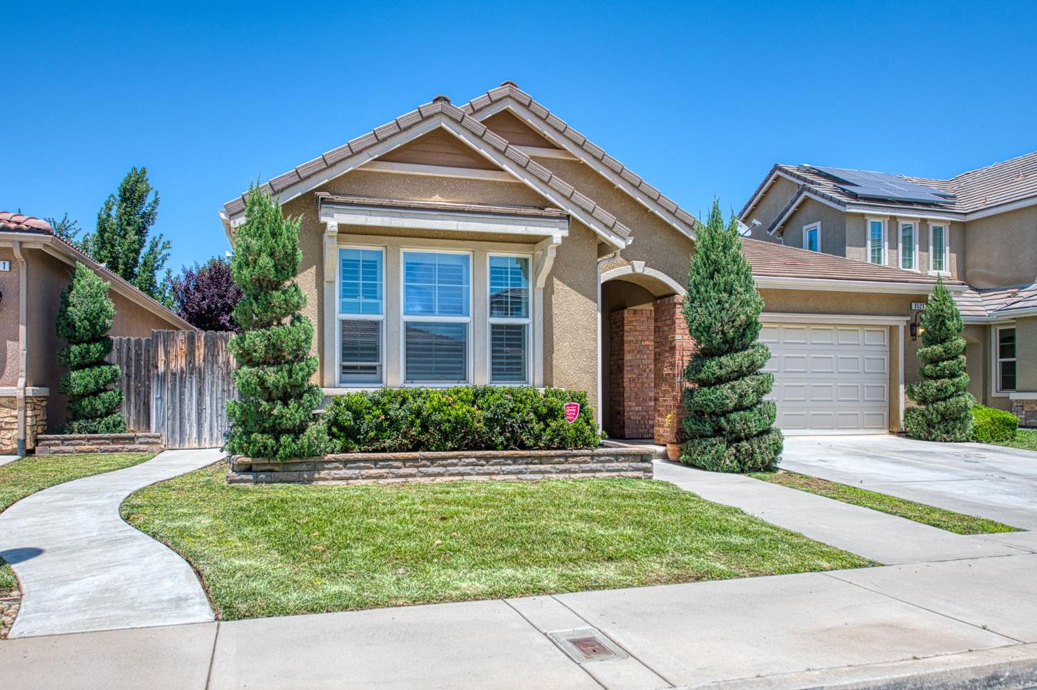 3521 Buckingham Avenue Clovis, CA 93619 - Photo 1 of 33 a front view of a house with a yard