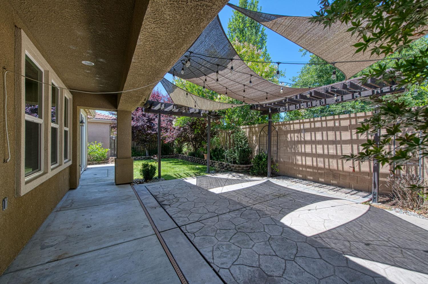 3521 Buckingham Avenue Clovis, CA 93619 - Photo 27 of 33 a view of a patio with table and chairs a barbeque with wooden fence