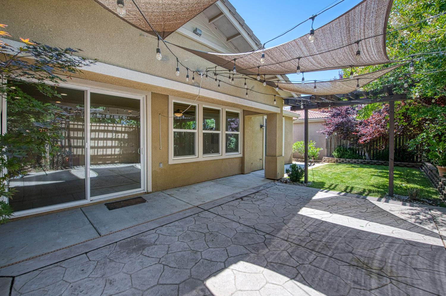 3521 Buckingham Avenue Clovis, CA 93619 - Photo 28 of 33 a view of a house with a yard and potted plants