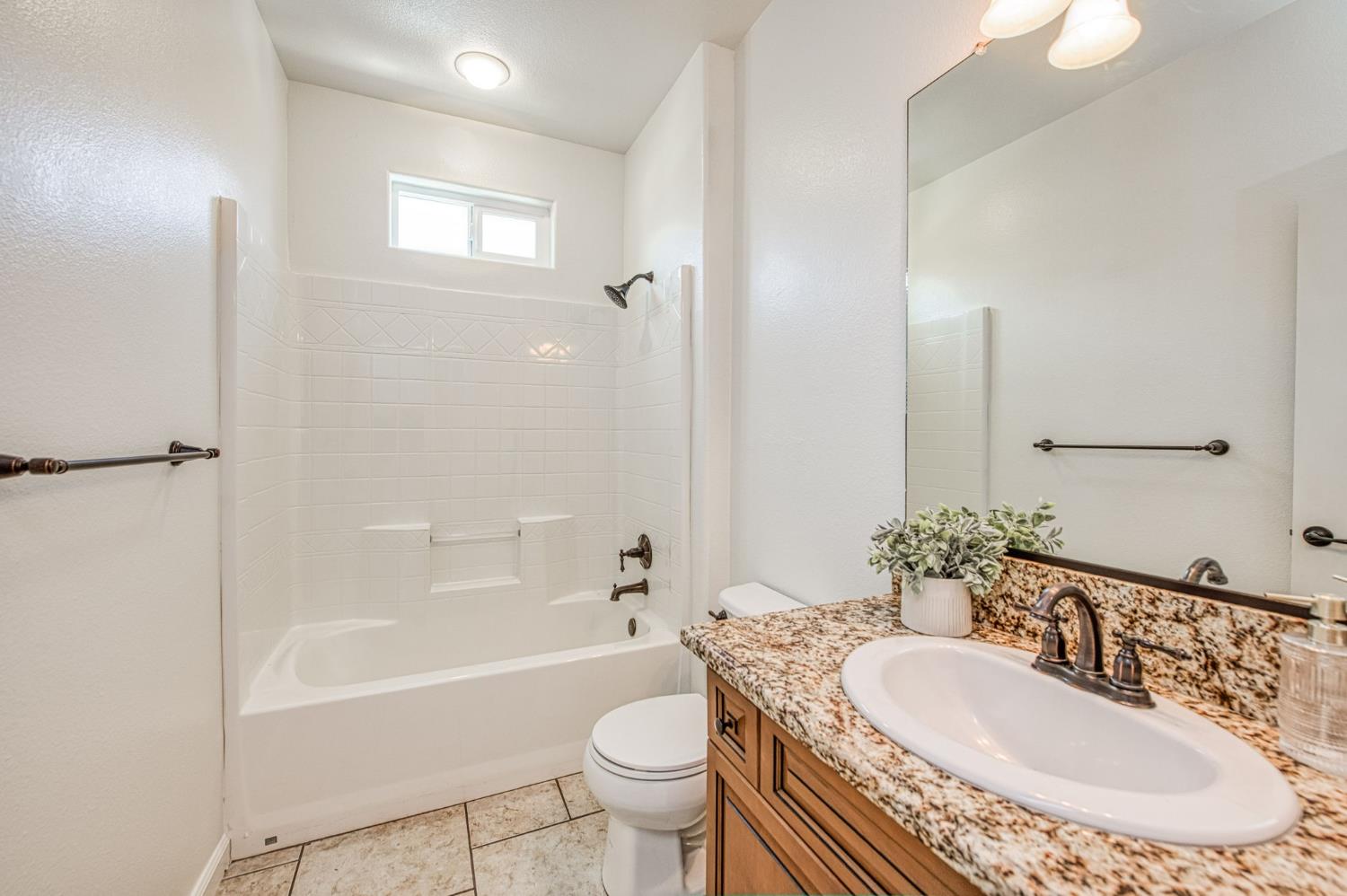 3521 Buckingham Avenue Clovis, CA 93619 - Photo 8 of 33 a bathroom with a sink a toilet and shower