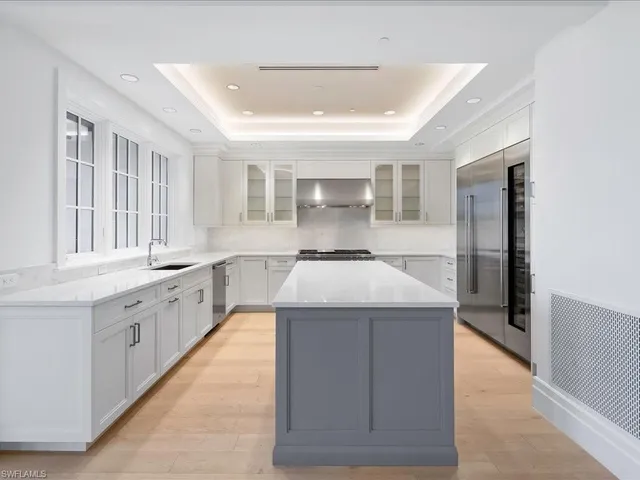 a kitchen with stainless steel appliances kitchen island a cabinets and wooden floor