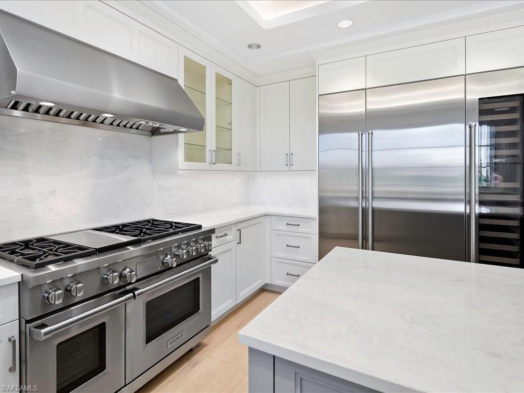 745 12th Avenue South, Unit 102 Naples, FL 34102 - Photo 16 of 50 a kitchen with cabinets and stainless steel appliances