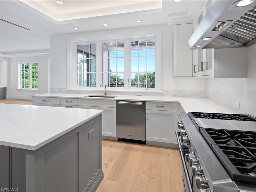 745 12th Avenue South, Unit 102 Naples, FL 34102 - Photo 17 of 50 a kitchen with a stove and a sink