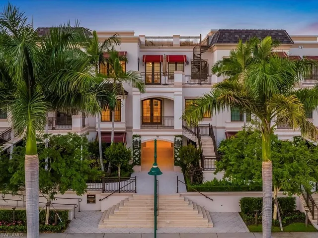 a front view of multiple houses with yard