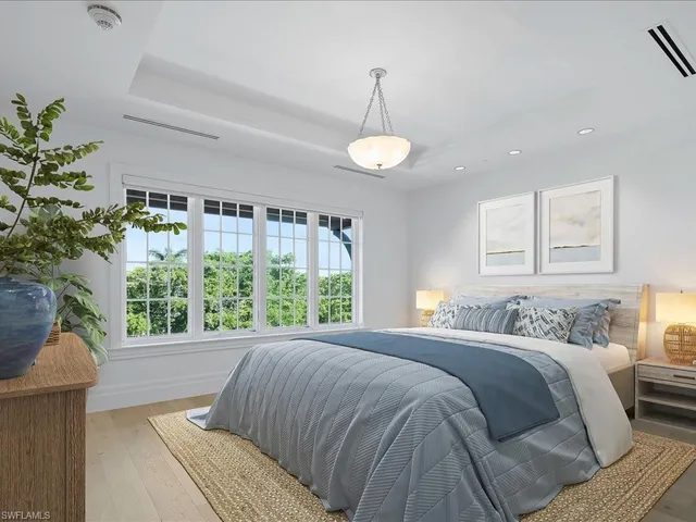 a bedroom with a large bed and a large window