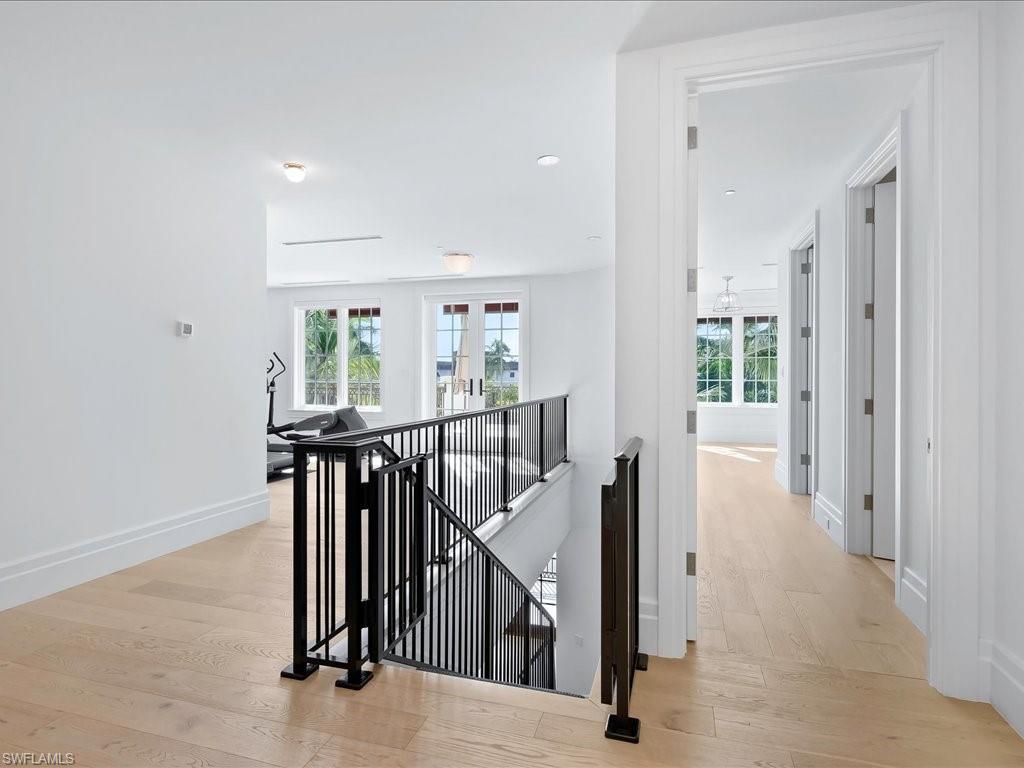 745 12th Avenue South, Unit 102 Naples, FL 34102 - Photo 32 of 50 en view interior of a house with wooden floor and stairs