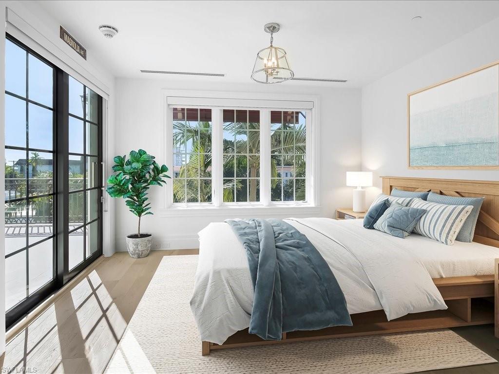 745 12th Avenue South, Unit 102 Naples, FL 34102 - Photo 35 of 50 a bedroom with a large bed and a large window