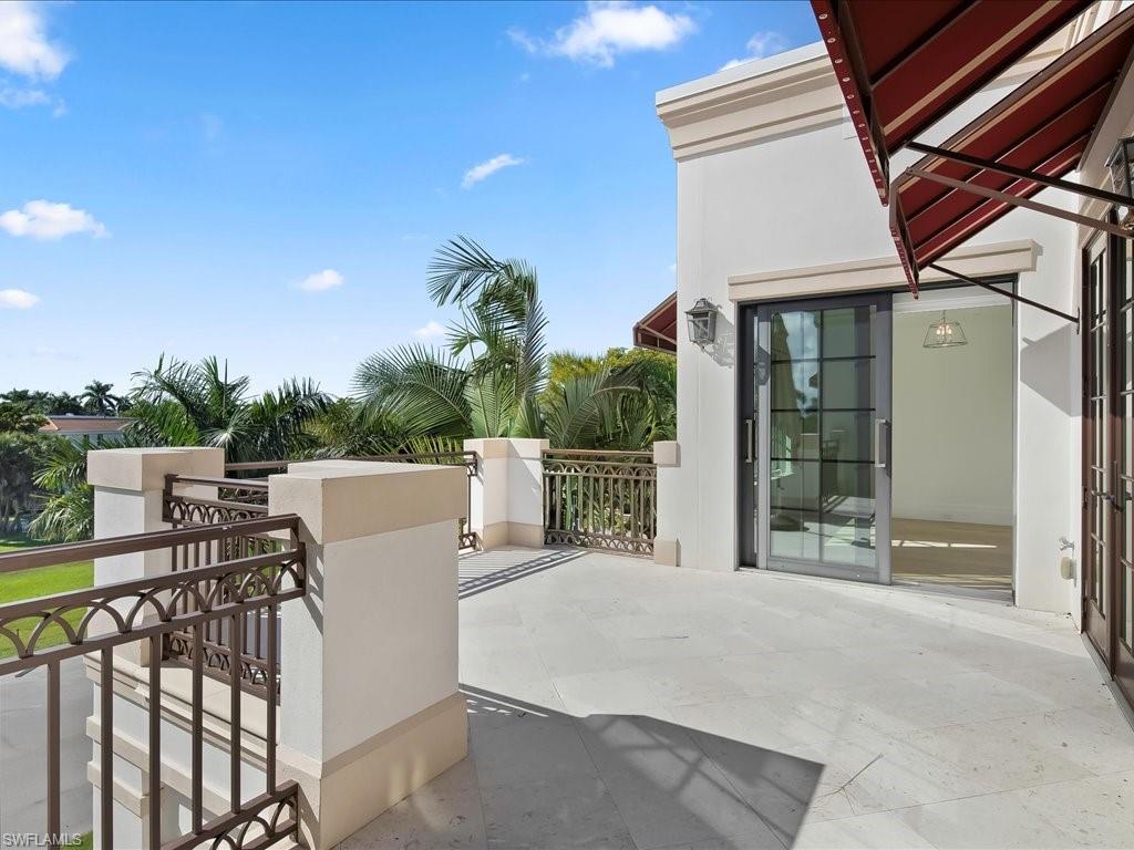 745 12th Avenue South, Unit 102 Naples, FL 34102 - Photo 37 of 50 a view of a patio with table and chairs with wooden floor and fence
