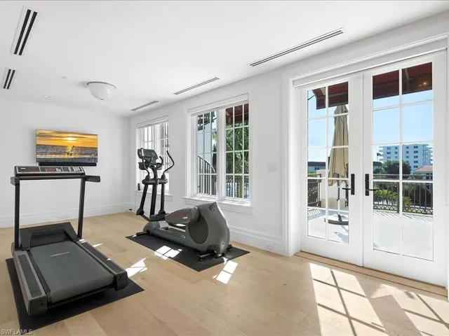 a room with gym equipment and a large window