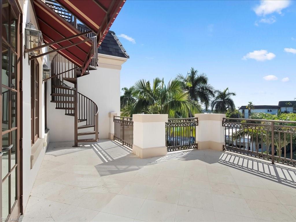 745 12th Avenue South, Unit 102 Naples, FL 34102 - Photo 39 of 50 a view of a chair and tables in the balcony