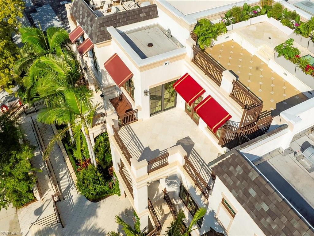 745 12th Avenue South, Unit 102 Naples, FL 34102 - Photo 48 of 50 an aerial view of residential house with outdoor space and trees