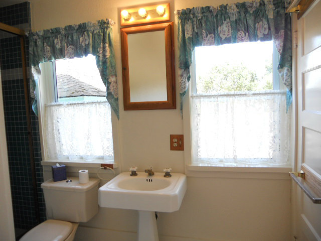 864 Green Valley Road Watsonville, CA 95076 - Photo 24 of 25 a bathroom with a sink toilet and a mirror