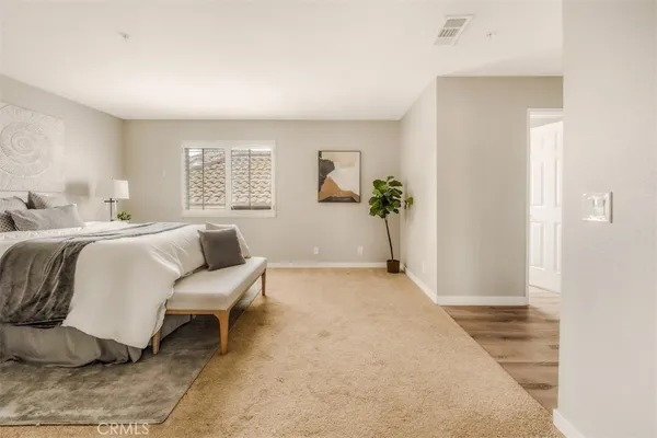 a spacious bedroom with a bed and a table