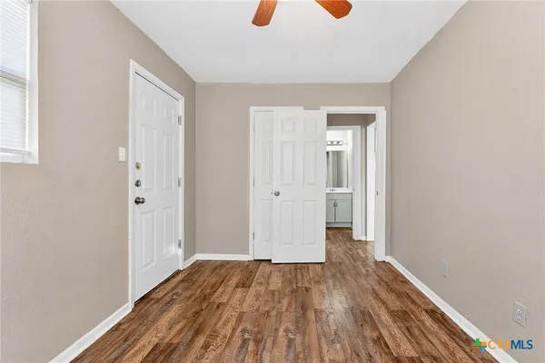 a view of a hallway with wooden floor