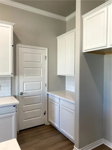 a kitchen with white cabinets and a sink