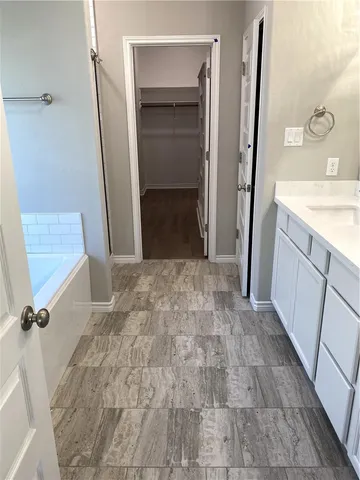 a bathroom with a sink a mirror and a shower