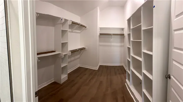 a view of walk in closet with empty racks
