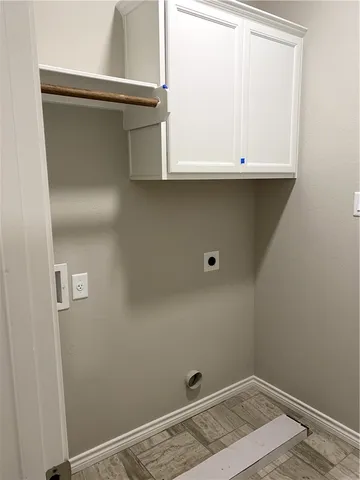a view of storage and utility room with wooden floor