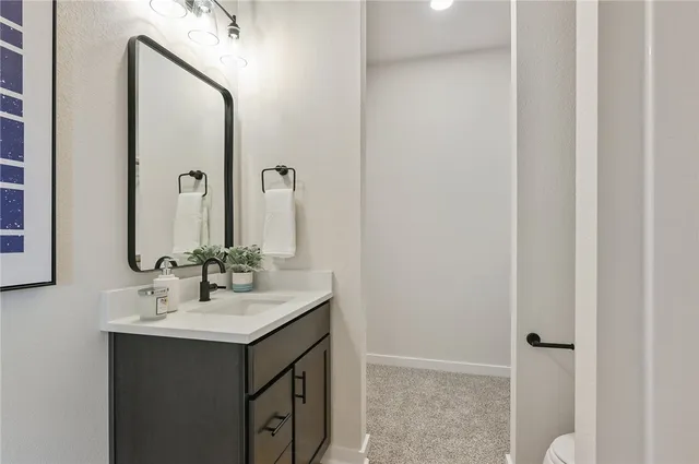 a bathroom with a bathtub sink vanity and mirror
