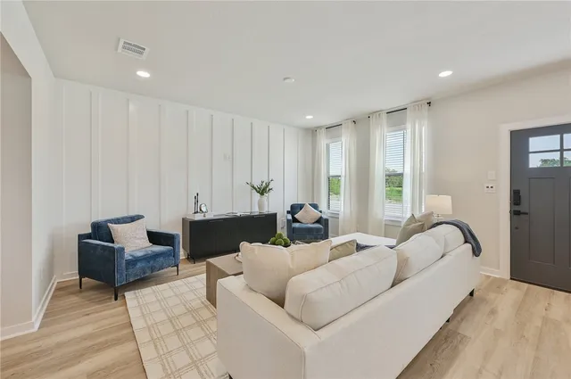 a view of a dining room with furniture a chandelier and window