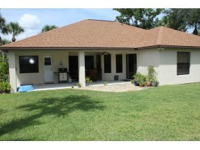 2513 Southern Melbourne, FL 32901 - Photo 2 of 12 a view of a brick house with a yard potted plants and a table