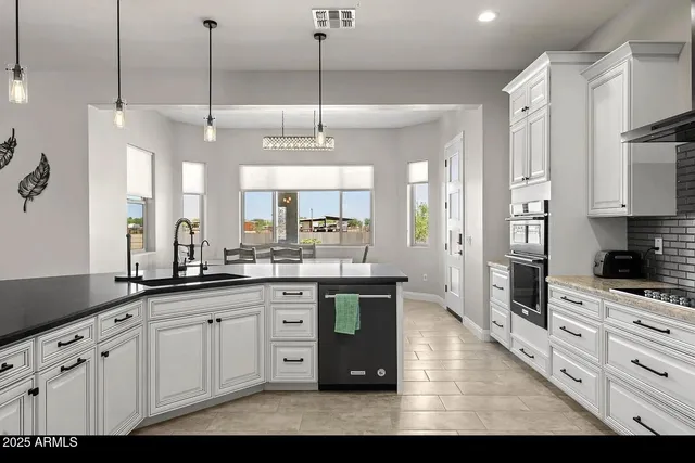 a kitchen with granite countertop cabinets and steel stainless steel appliances