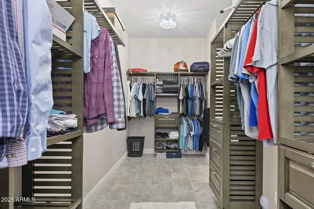 a bedroom with a bed and a flat tv screen on dresser
