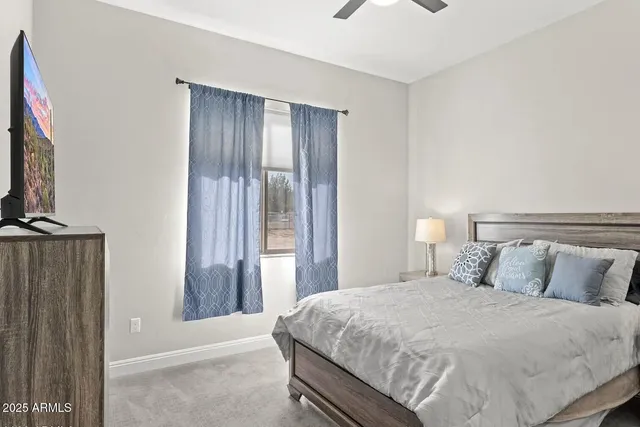 a bathroom with a granite countertop sink a toilet and a mirror