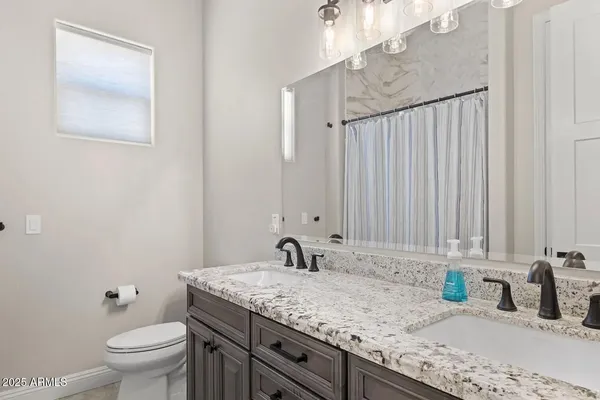 a bedroom with a bed and painting on the wall