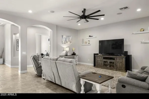 a living room with furniture and a chandelier