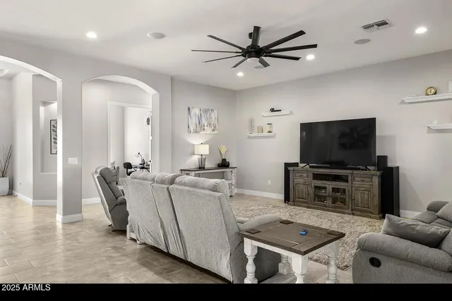 a living room with furniture and a chandelier