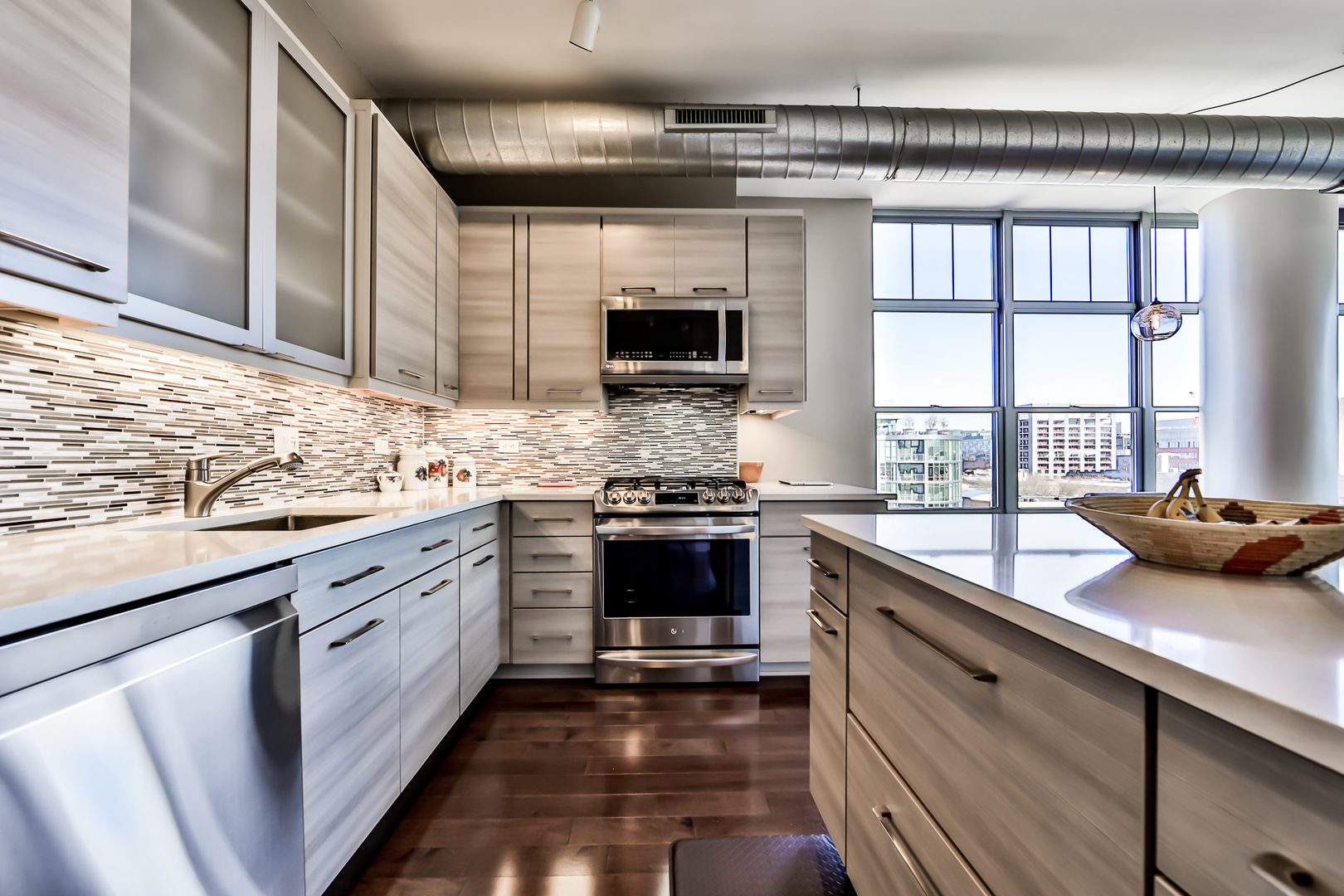 1200 West Monroe Street, Unit 801 Chicago, IL 60607 - Photo 12 of 26 a kitchen with stainless steel appliances kitchen island granite countertop a stove sink and cabinets