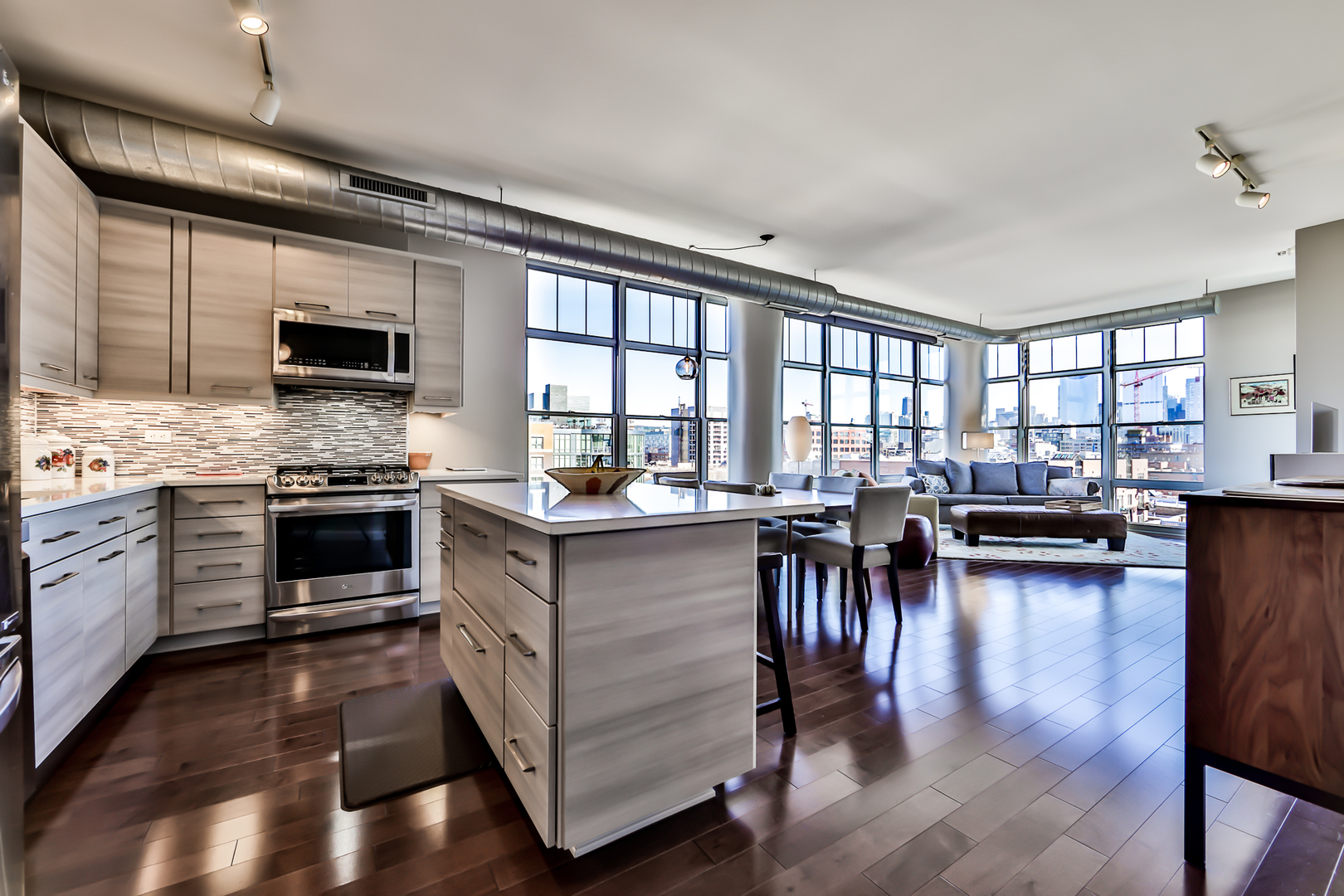 1200 West Monroe Street, Unit 801 Chicago, IL 60607 - Photo 13 of 26 a kitchen with a stove kitchen island and a wooden floor