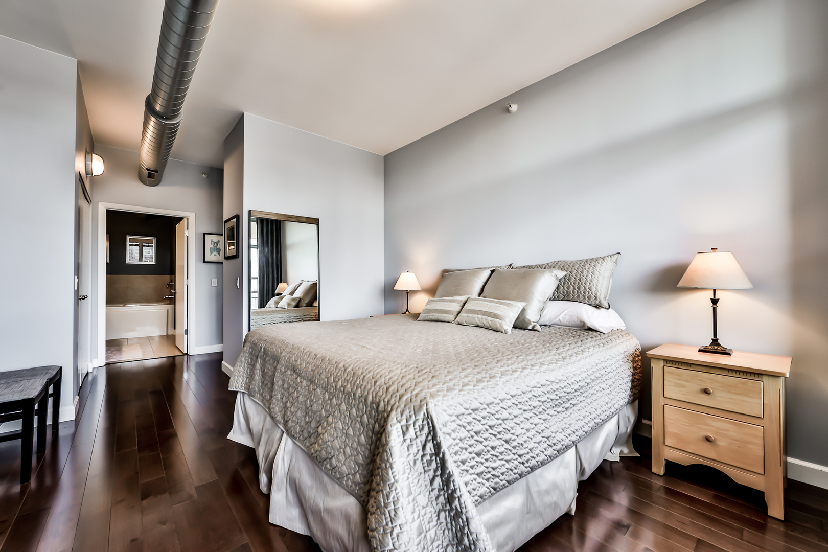 1200 West Monroe Street, Unit 801 Chicago, IL 60607 - Photo 15 of 26 a bedroom with a bed and wooden floor