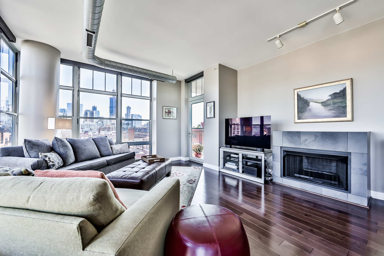 1200 West Monroe Street, Unit 801 Chicago, IL 60607 - Photo 2 of 26 a living room with furniture a flat screen tv and a fireplace