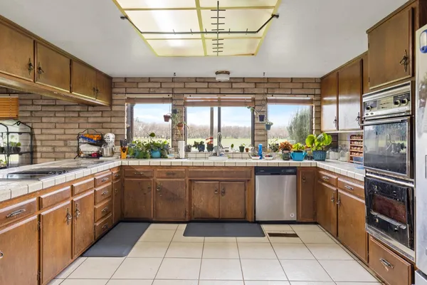 a kitchen with cabinets and appliances
