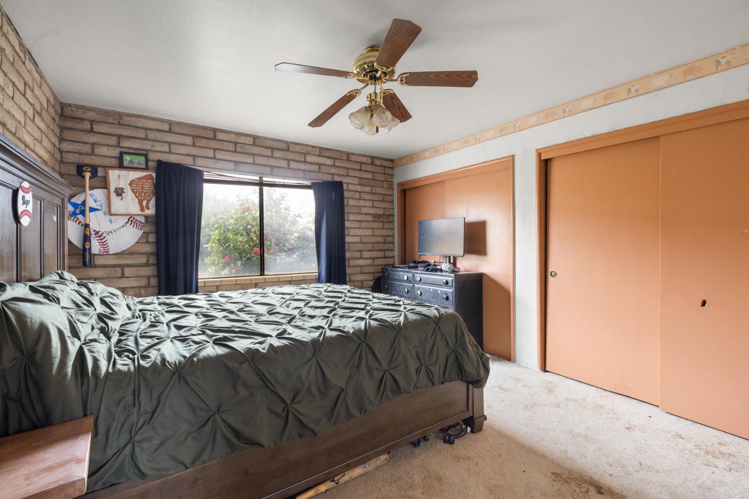 3781 Larkin Road Biggs, CA 95917 - Photo 14 of 34 a bed sitting in a bedroom next to a window