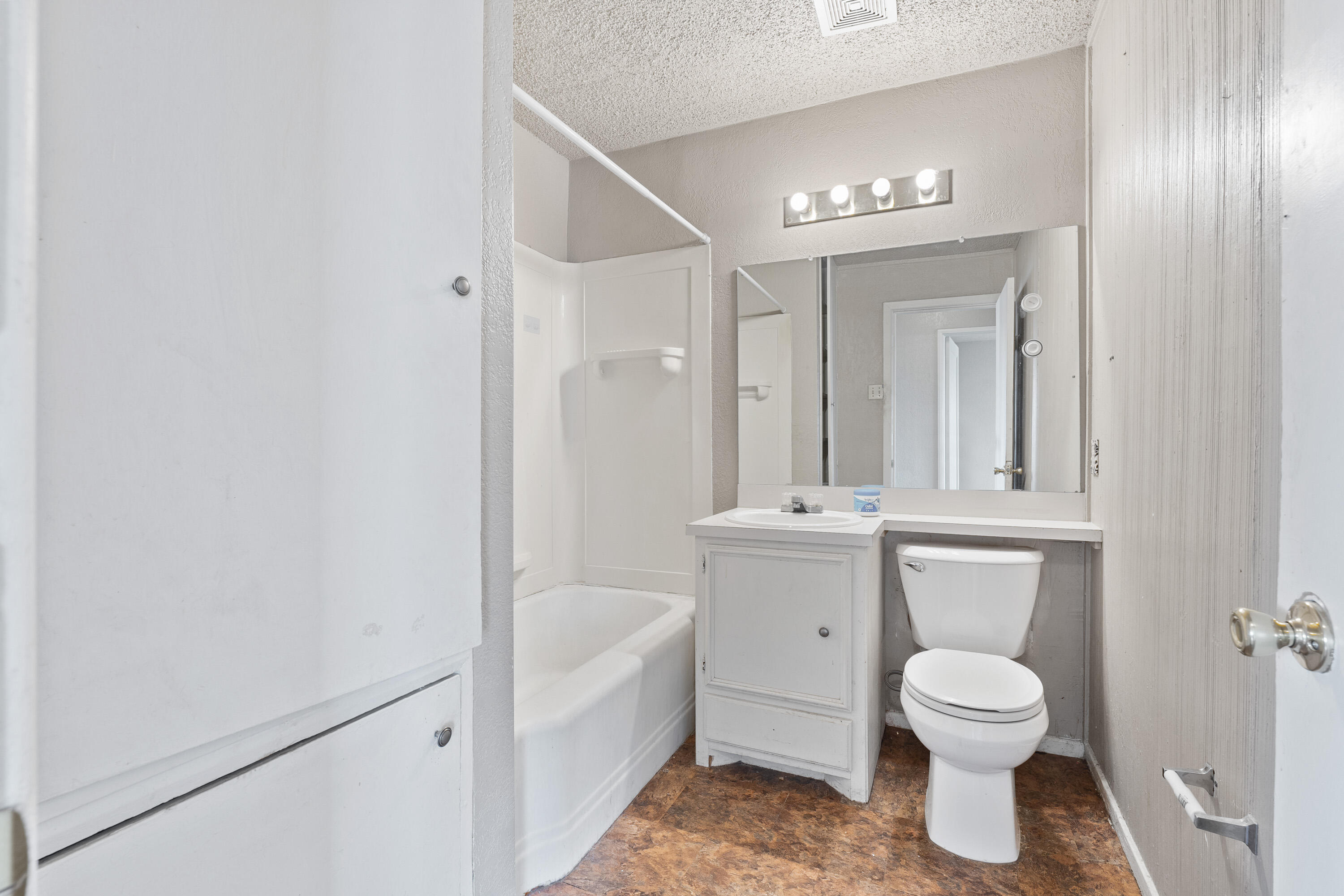 3602 31st Street Lubbock, TX 79410 - Photo 11 of 15 a bathroom with a toilet sink and mirror