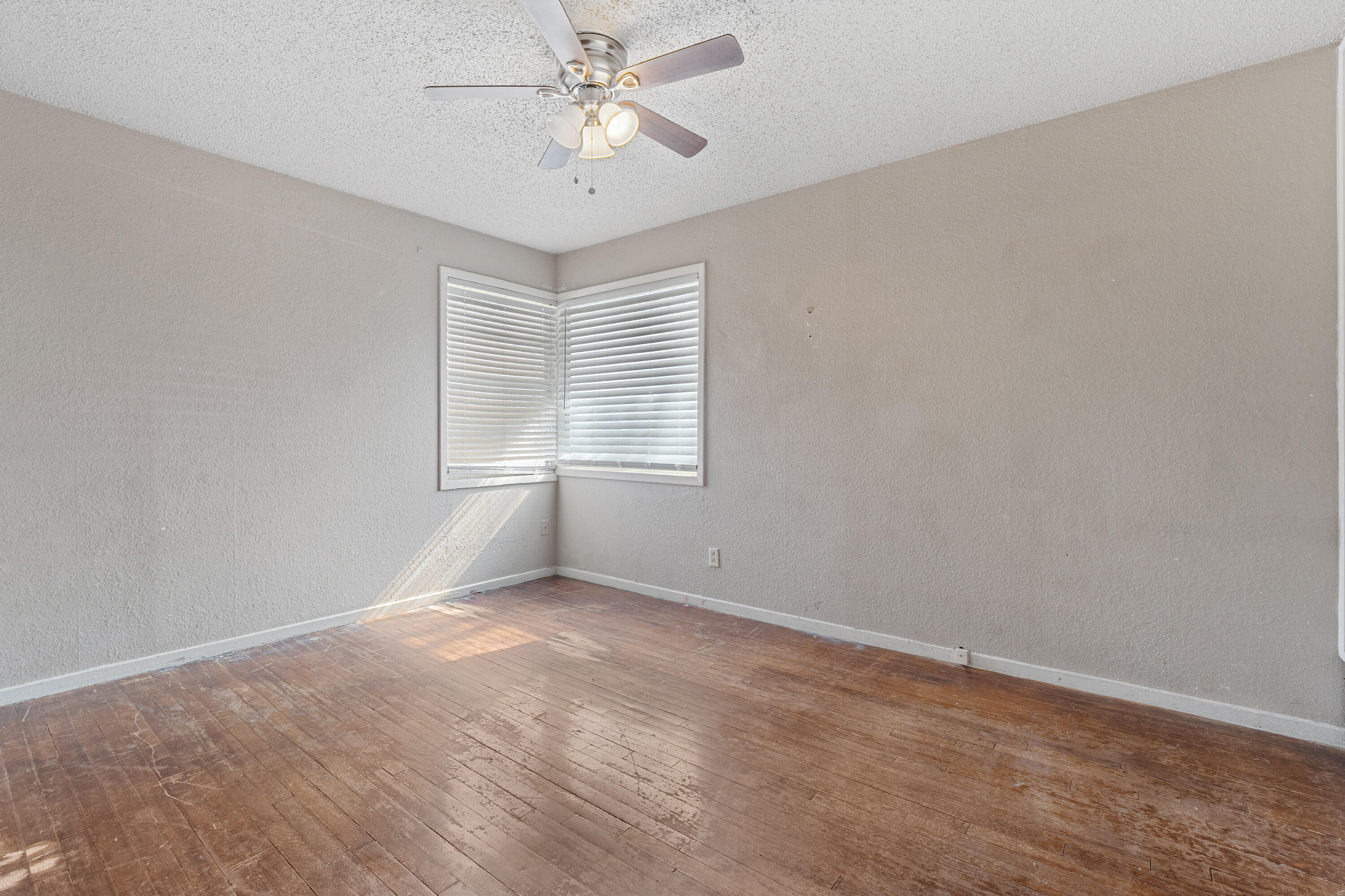 3602 31st Street Lubbock, TX 79410 - Photo 12 of 15 an empty room with a window and a fan