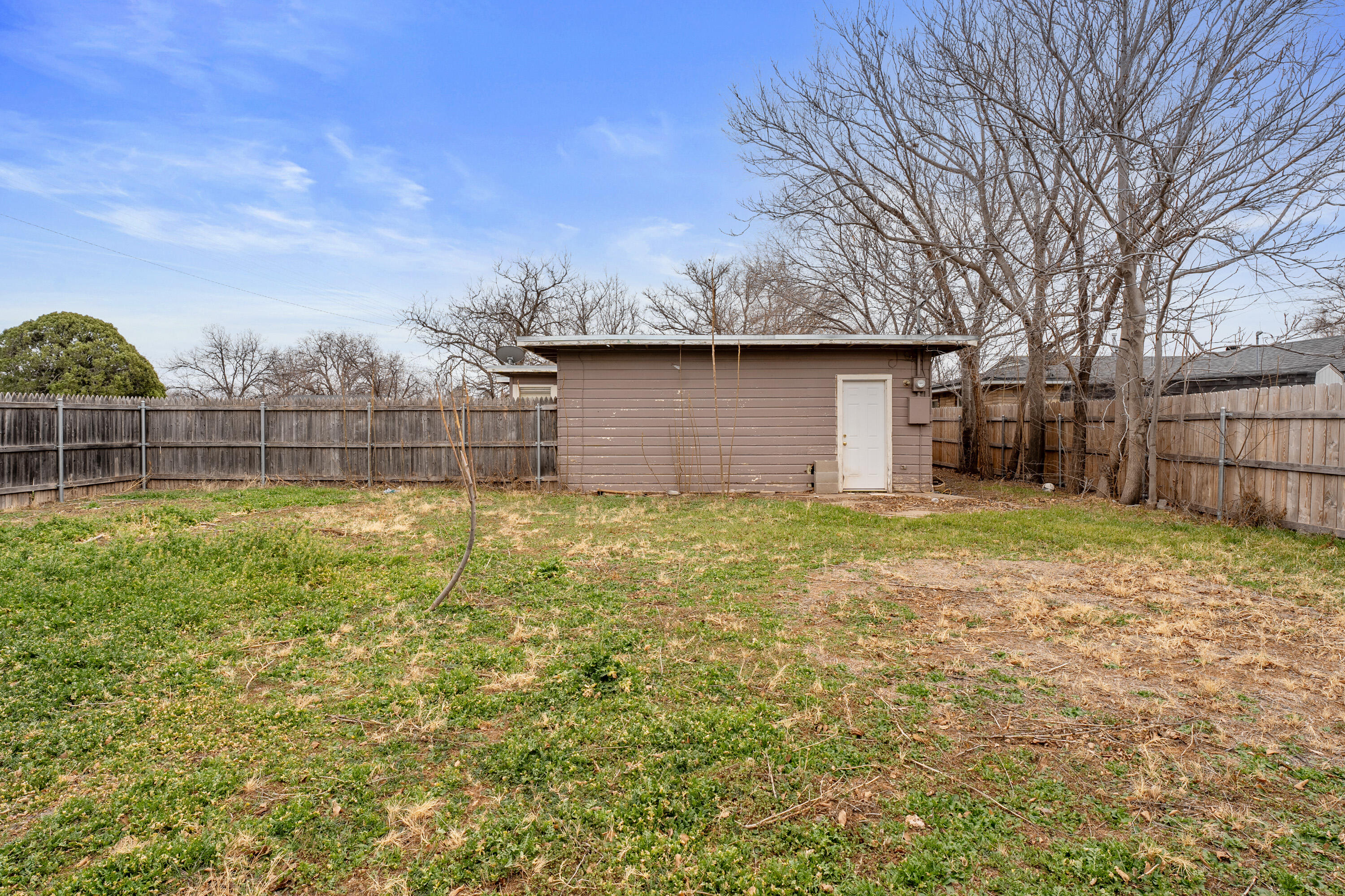 3602 31st Street Lubbock, TX 79410 - Photo 14 of 15 a backyard of a house with lots of green space