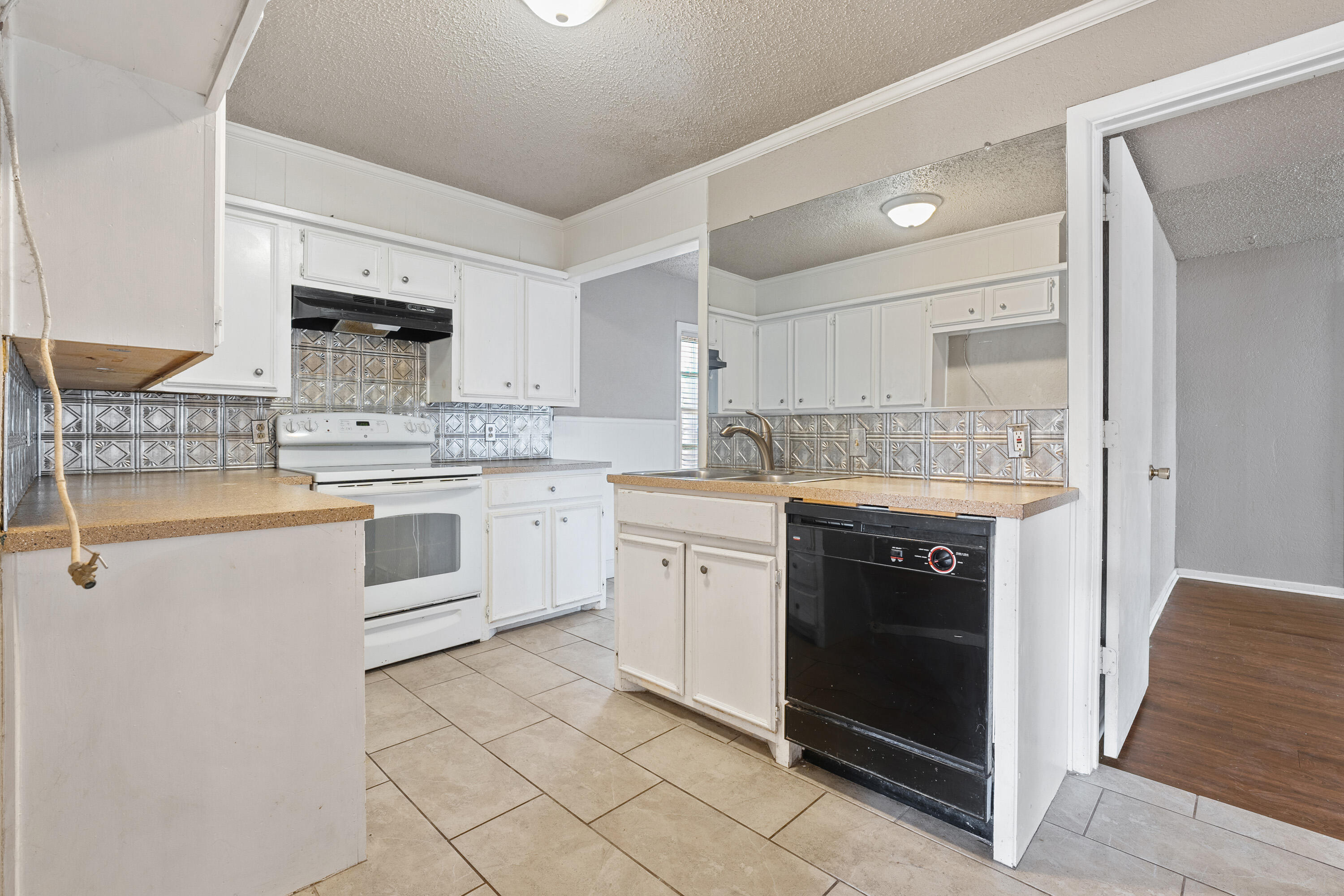 3602 31st Street Lubbock, TX 79410 - Photo 6 of 15 a kitchen with a sink stove and cabinets