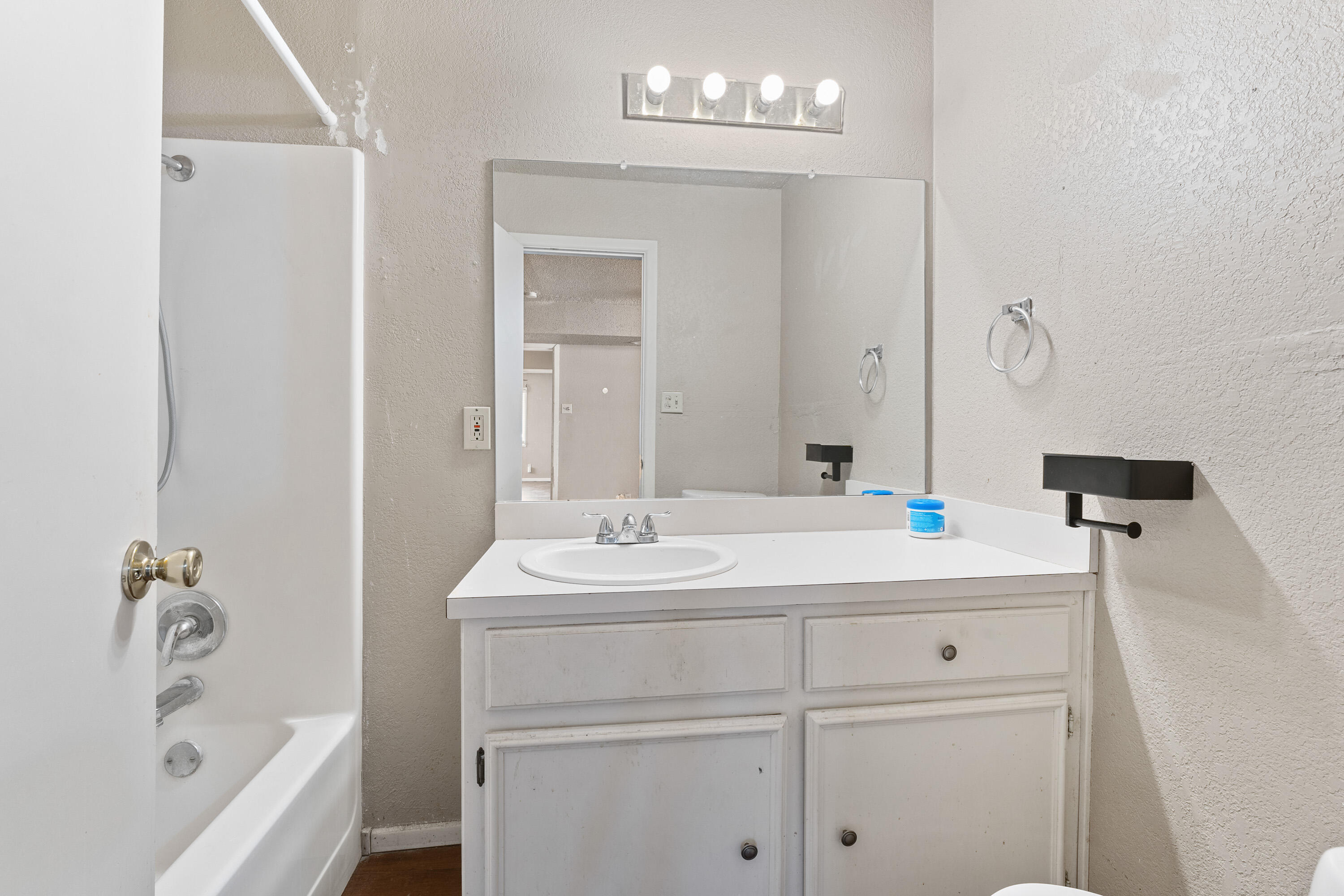 3602 31st Street Lubbock, TX 79410 - Photo 8 of 15 a bathroom with a bathtub sink a mirror and vanity