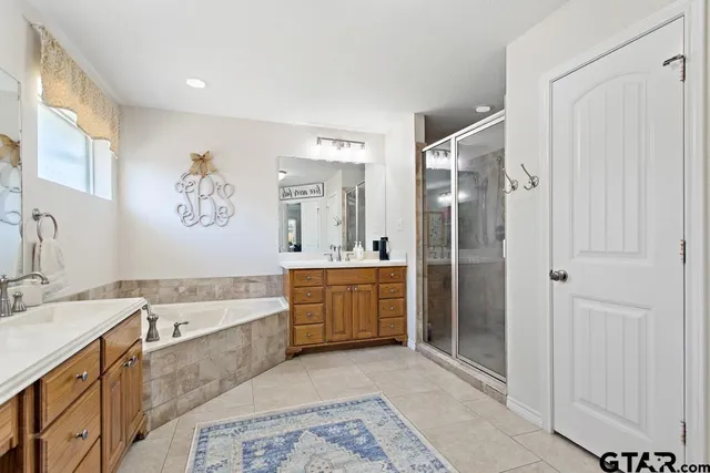 a bathroom with a tub a sink and mirrors