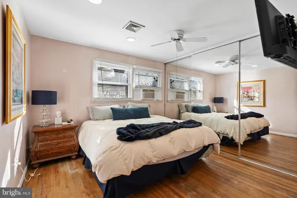 a bedroom with two beds and a flat screen tv