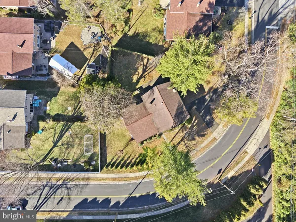an aerial view of a residential houses with yard