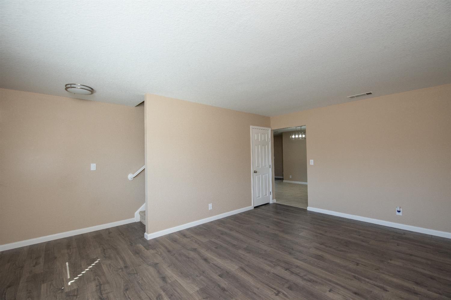 1621 Davis Street Ripon, CA 95366 - Photo 15 of 43 unfurnished room with dark wood-type flooring and baseboards