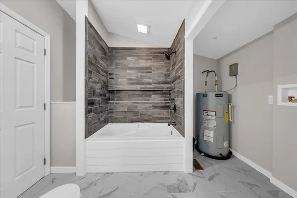 a bathroom with a bathtub and shower