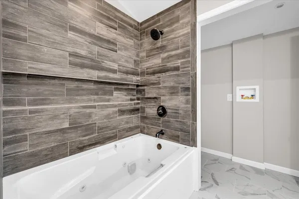 a bathroom with a bathtub and shower