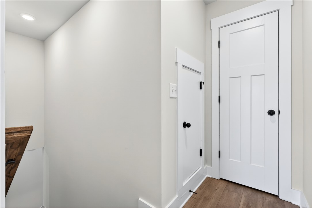 128 Whitman Way Easley, SC 29642 - Photo 20 of 34 This entry features sleek white doors, durable wood flooring, and recessed lighting.